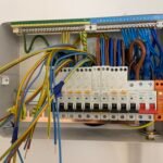 Open consumer unit showcasing meticulous electrical wiring and circuit breakers during a replacement service